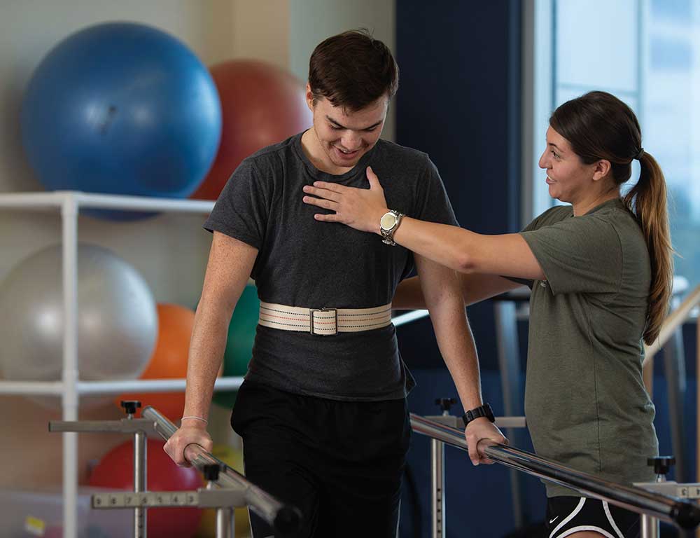 Physical Therapist Assistant helps patient