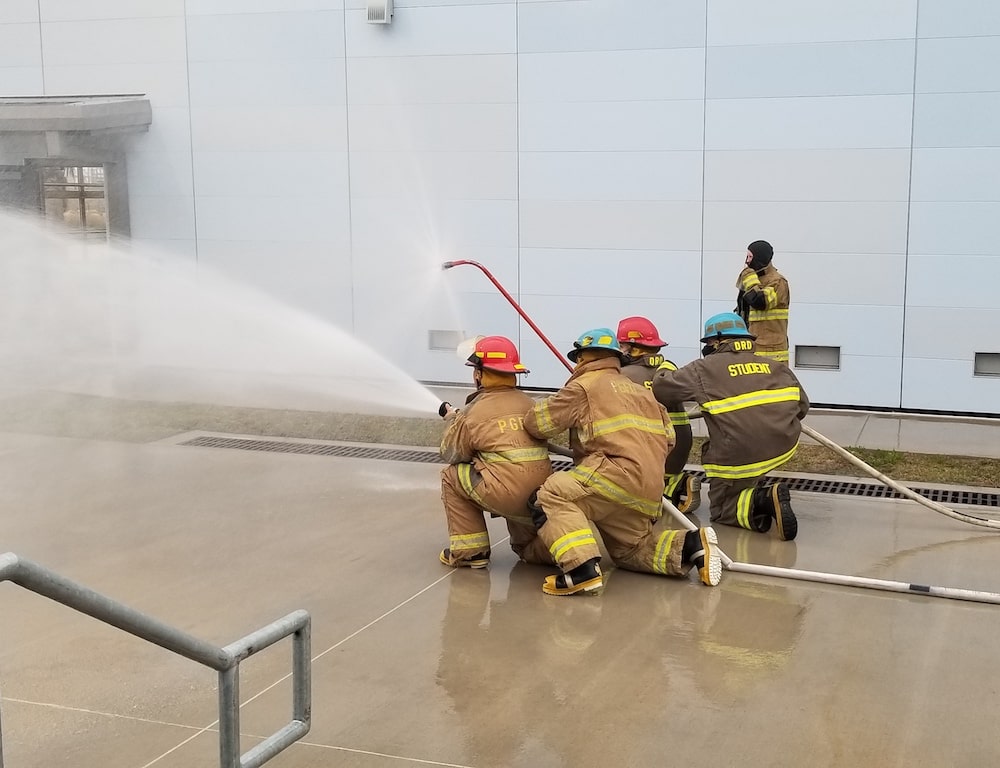 Students training with a fire hose