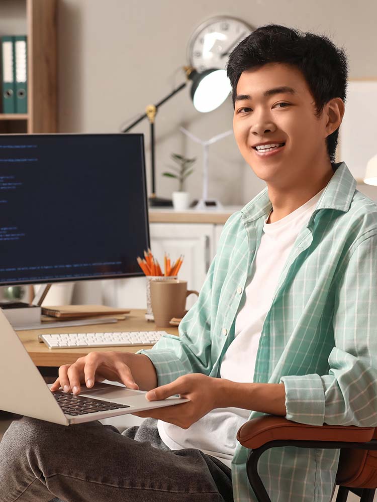 Coder smiling at camera.