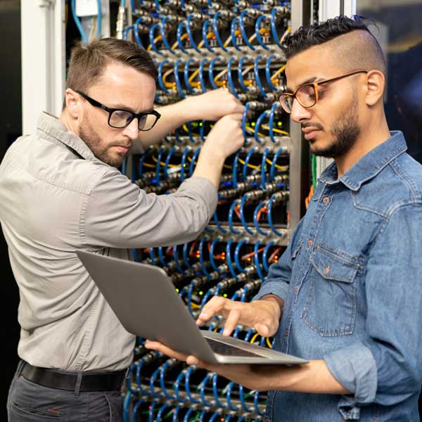 Technicians working on electrical computer system